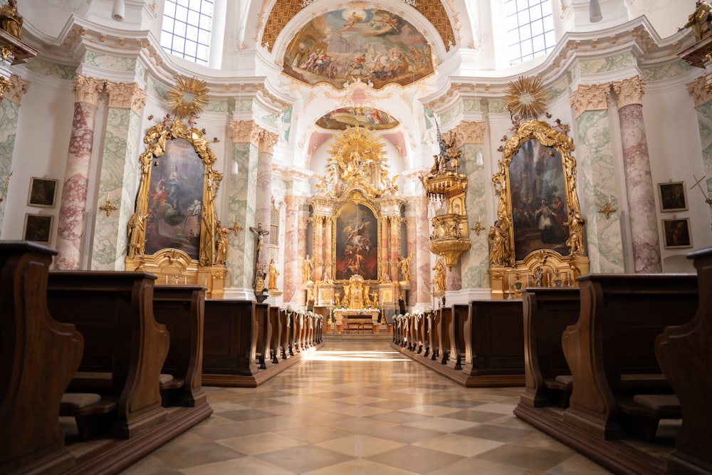 a large ornate room with a large chandelier and statues