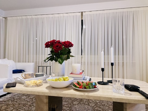 A sleek marble top coffee table set in a cozy living room with soft natural light.