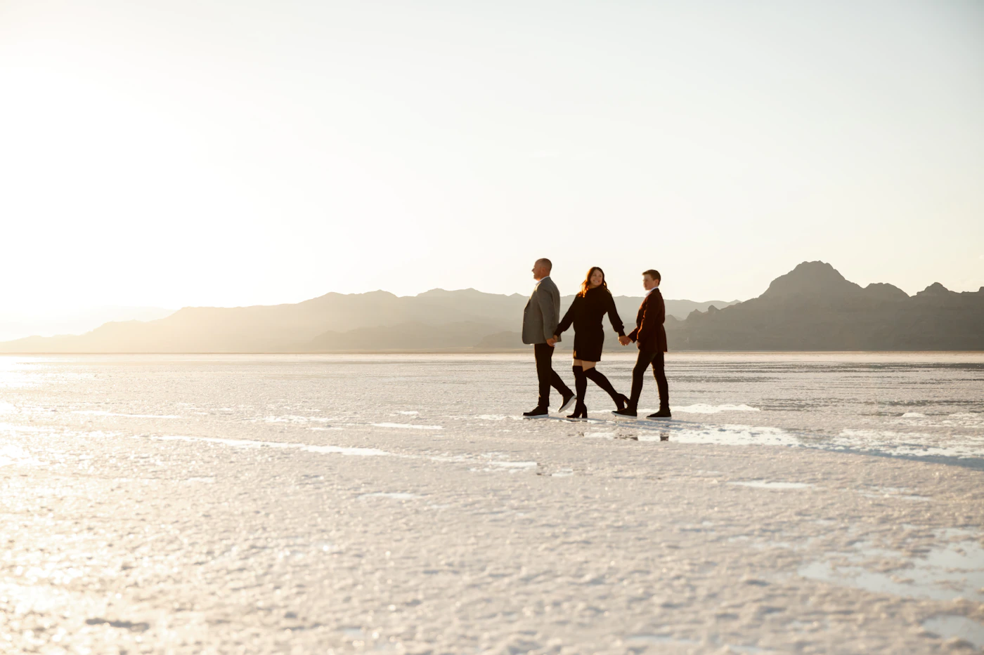 Couple in elopement attire at a Bolivian volcanic lagoon during their Salar de Uyuni elopement trip with the high-altitude landscape around them
