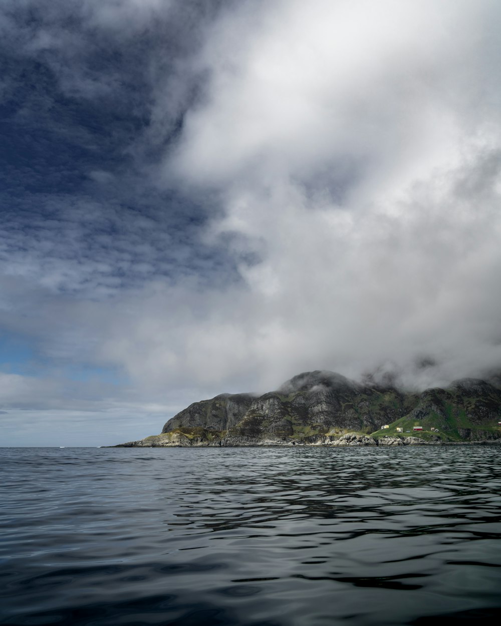 a body of water with a mountain in the distance