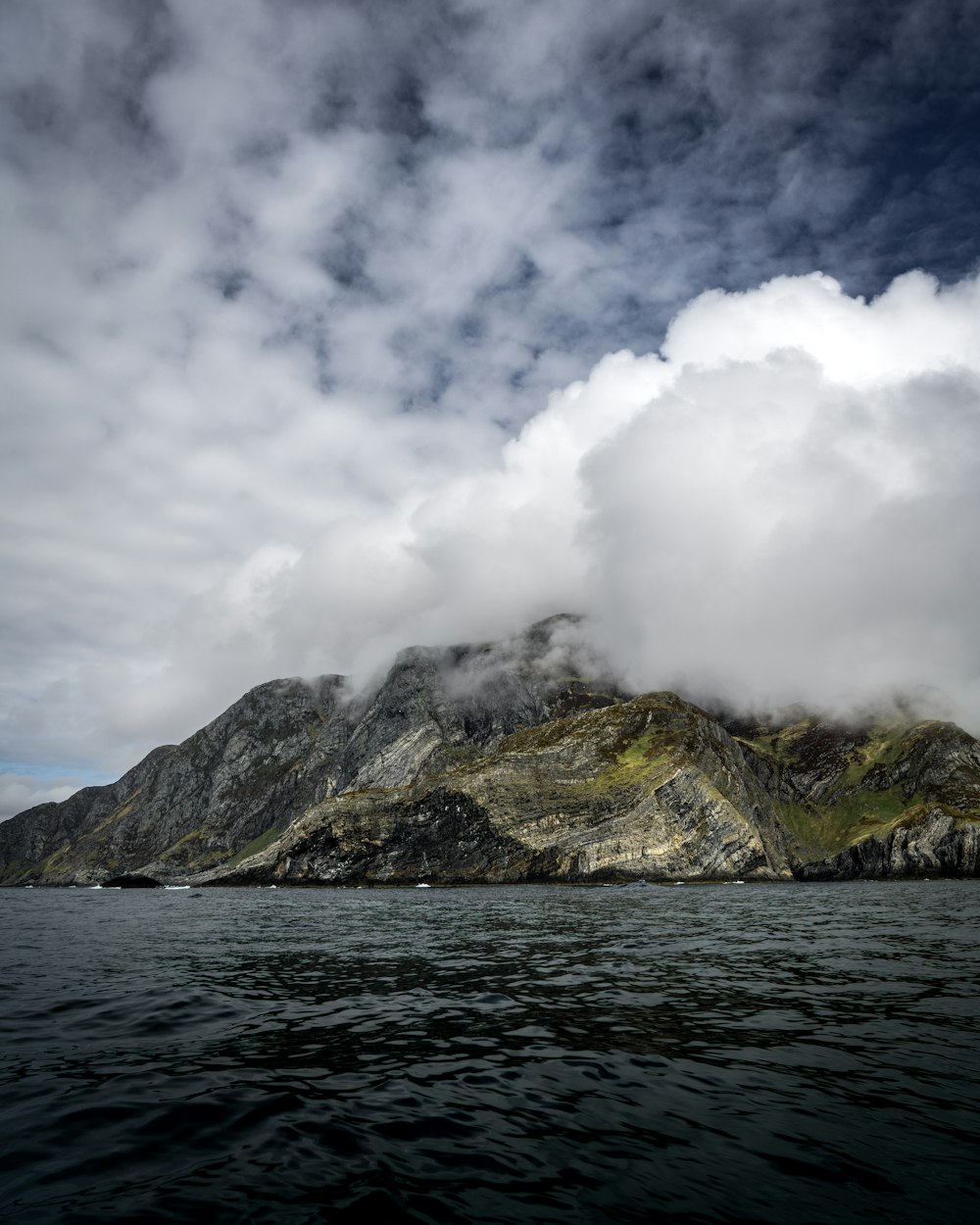 a body of water with a mountain in the background