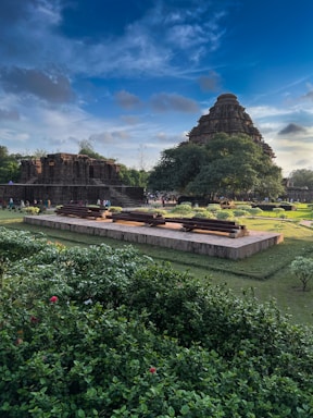 A stunning view of an ancient Indian monument surrounded by lush greenery.