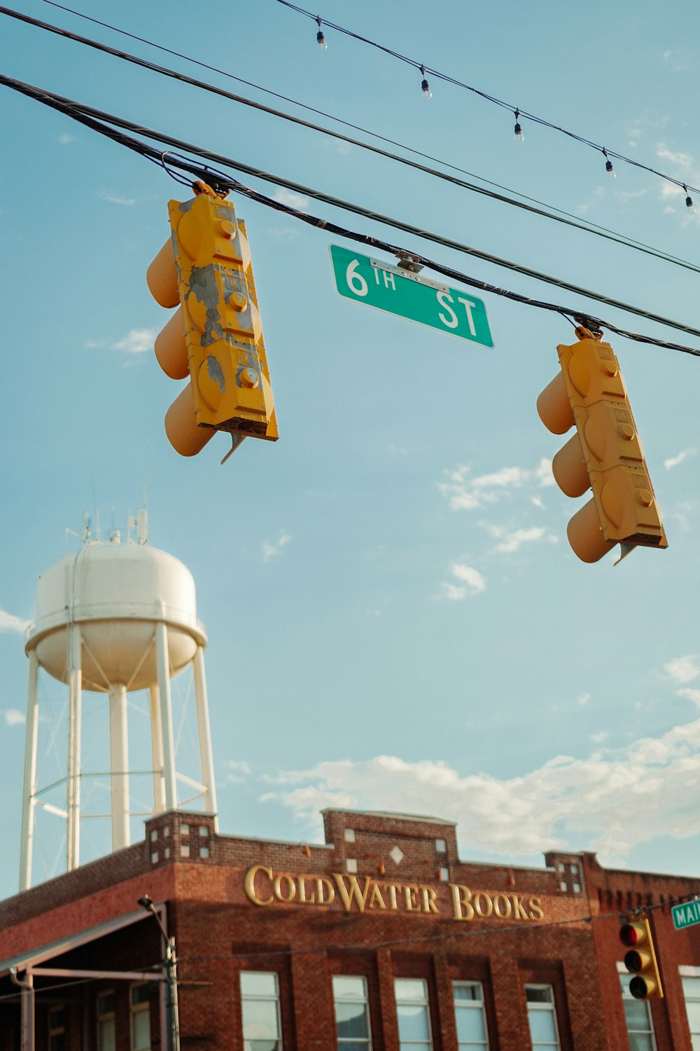 a street sign hangs over a traffic light