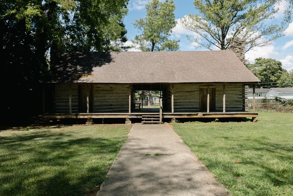 a wooden building with a grass yard