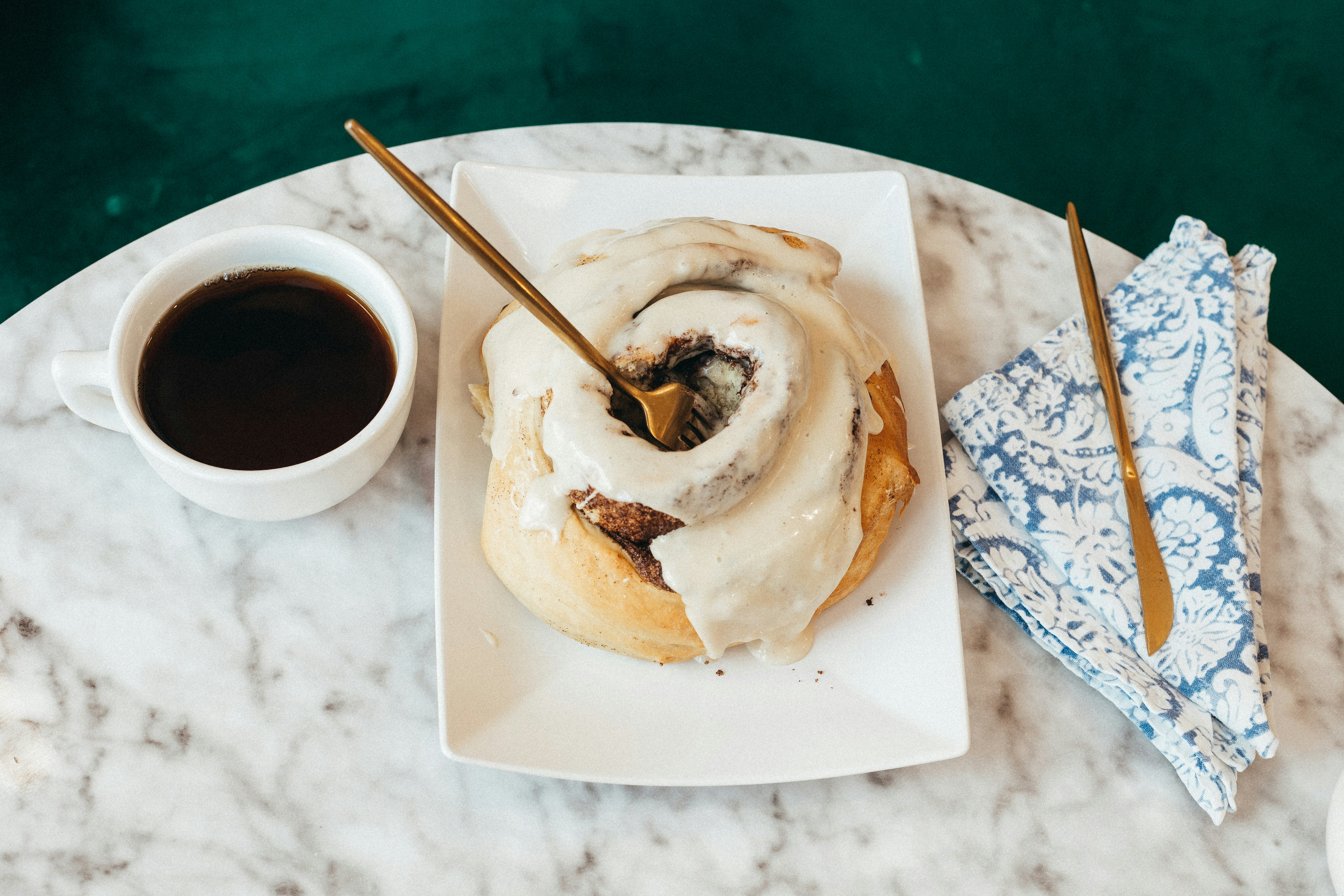 Iced cinnamon roll with coffee