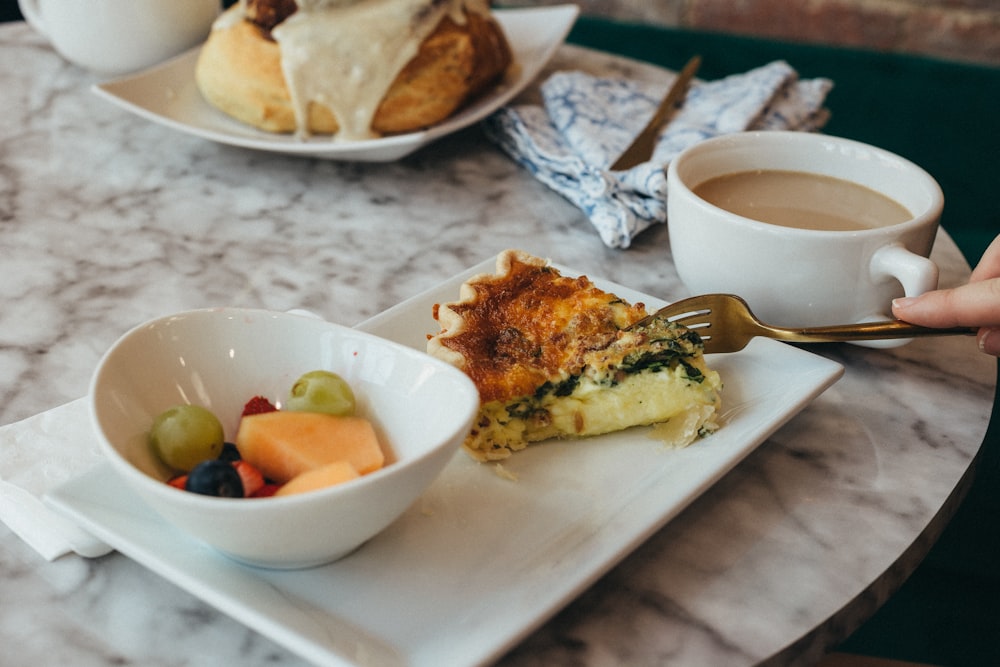 a plate of food and a cup of coffee