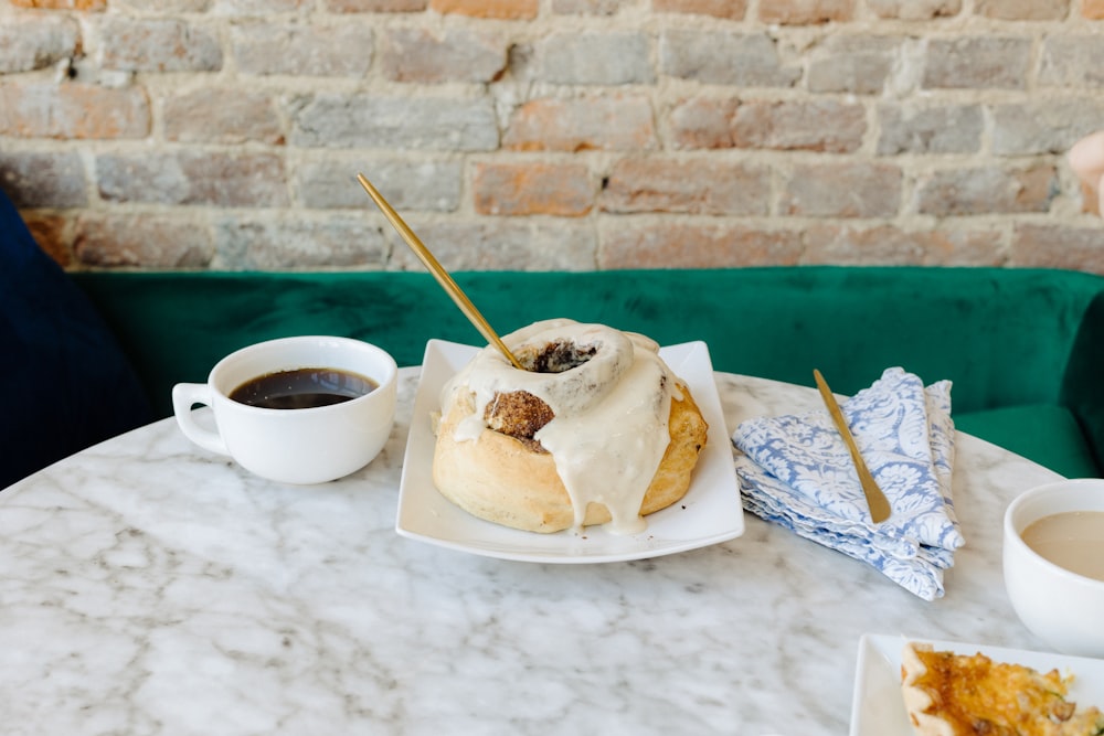 a plate of food and a cup of coffee on a table