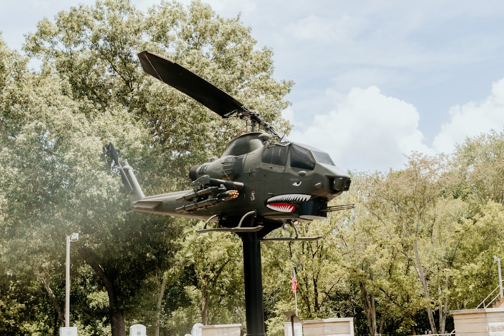 a helicopter flying over trees