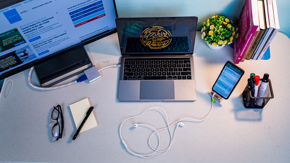 a laptop and a cell phone on a desk