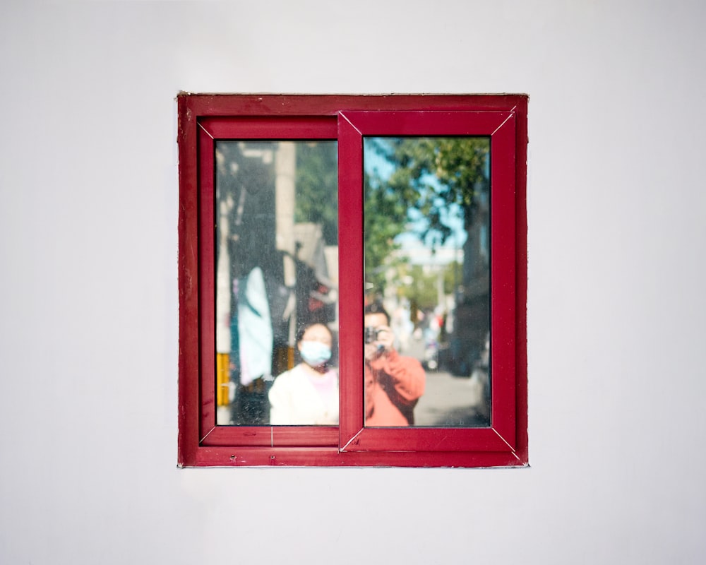 a red frame with a couple of people in it