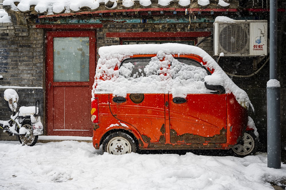 a red vehicle covered in snow