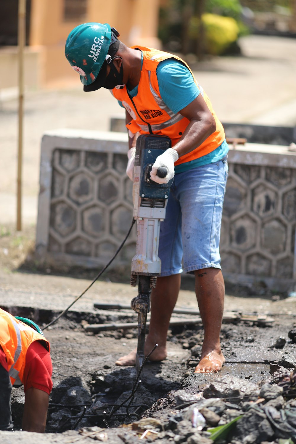 a person wearing a helmet and working on a piece of concrete