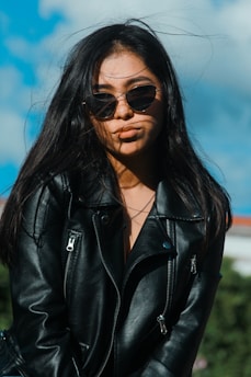 a woman with long hair and sunglasses