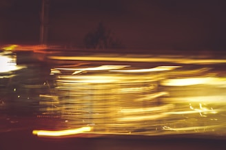 Print artwork capturing the energy of motorsport through fragmented shapes and light streaks.