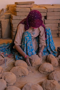 a person sitting on a pile of rocks