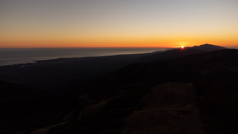 a sunset over a mountain