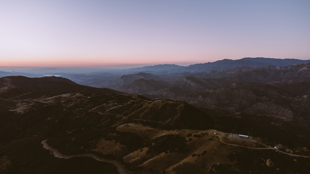 a landscape with hills and a road