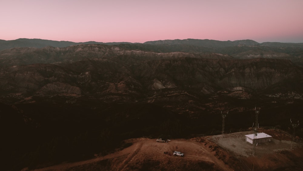 a landscape with hills and a car