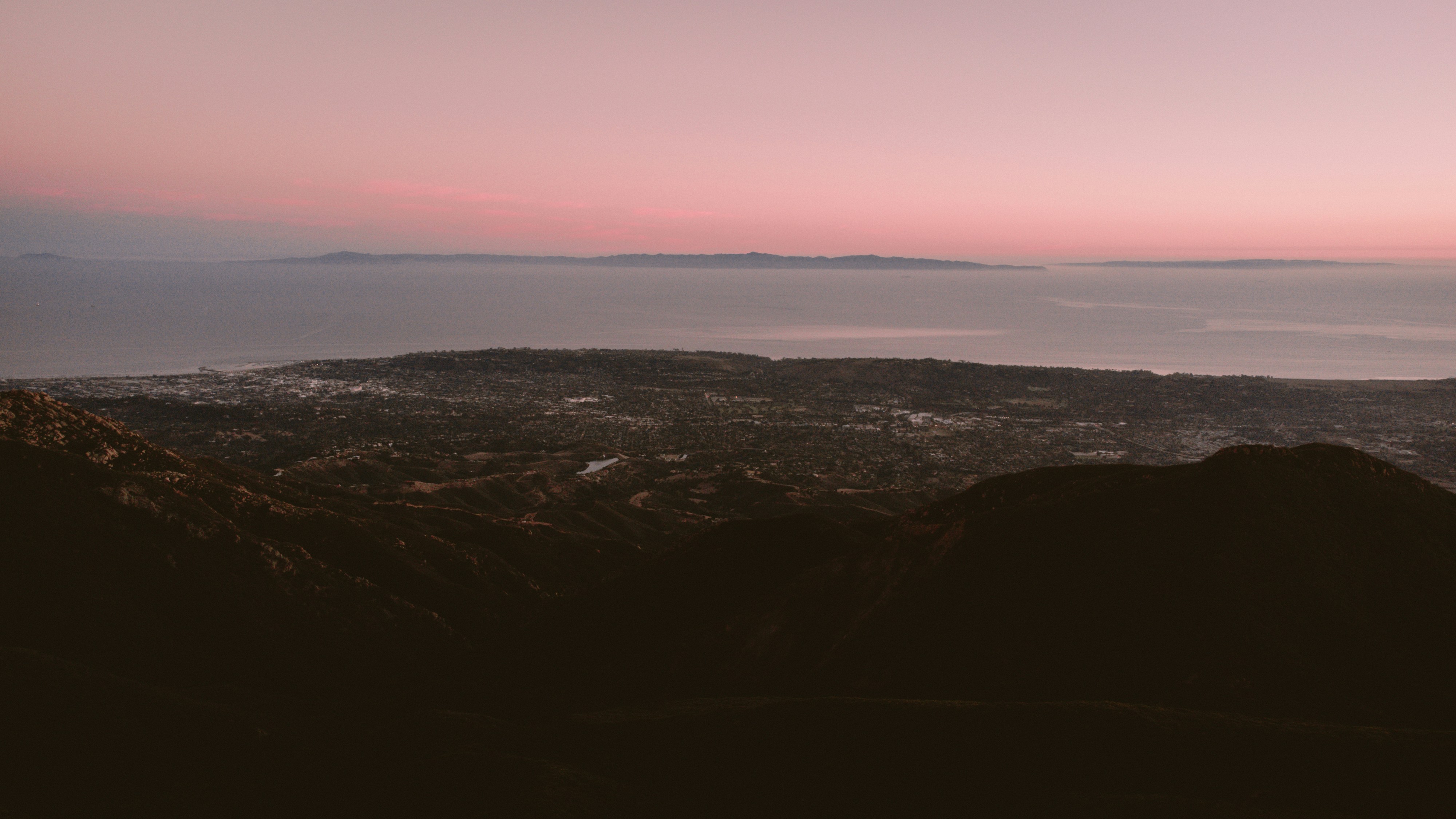 a landscape with a body of water in the distance