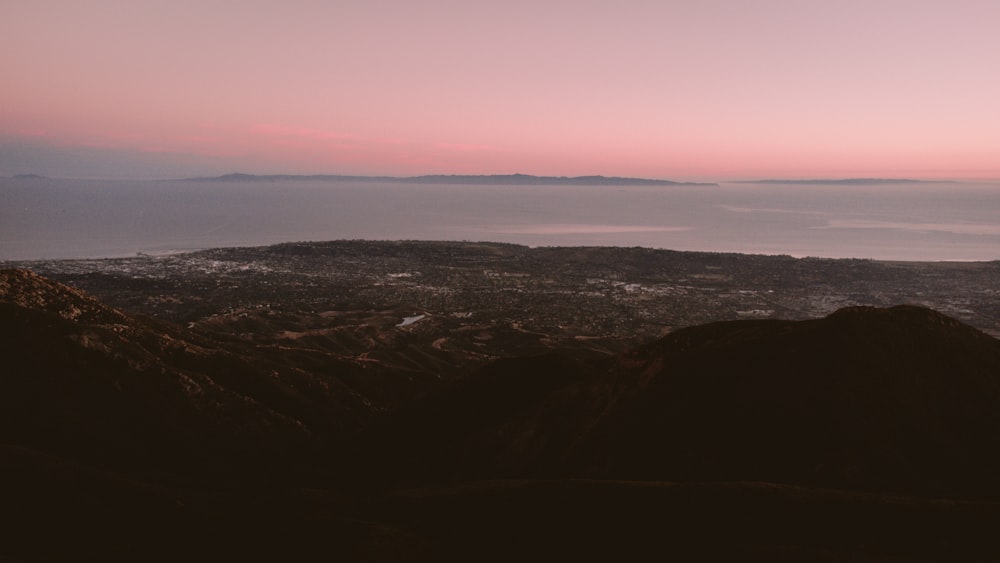 a landscape with a body of water in the distance