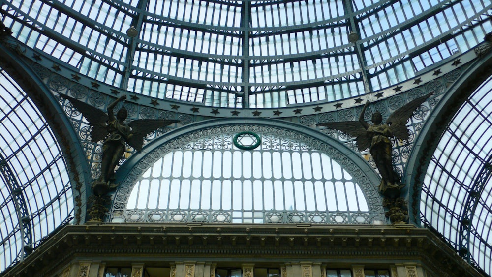 a large glass dome with a statue in the center