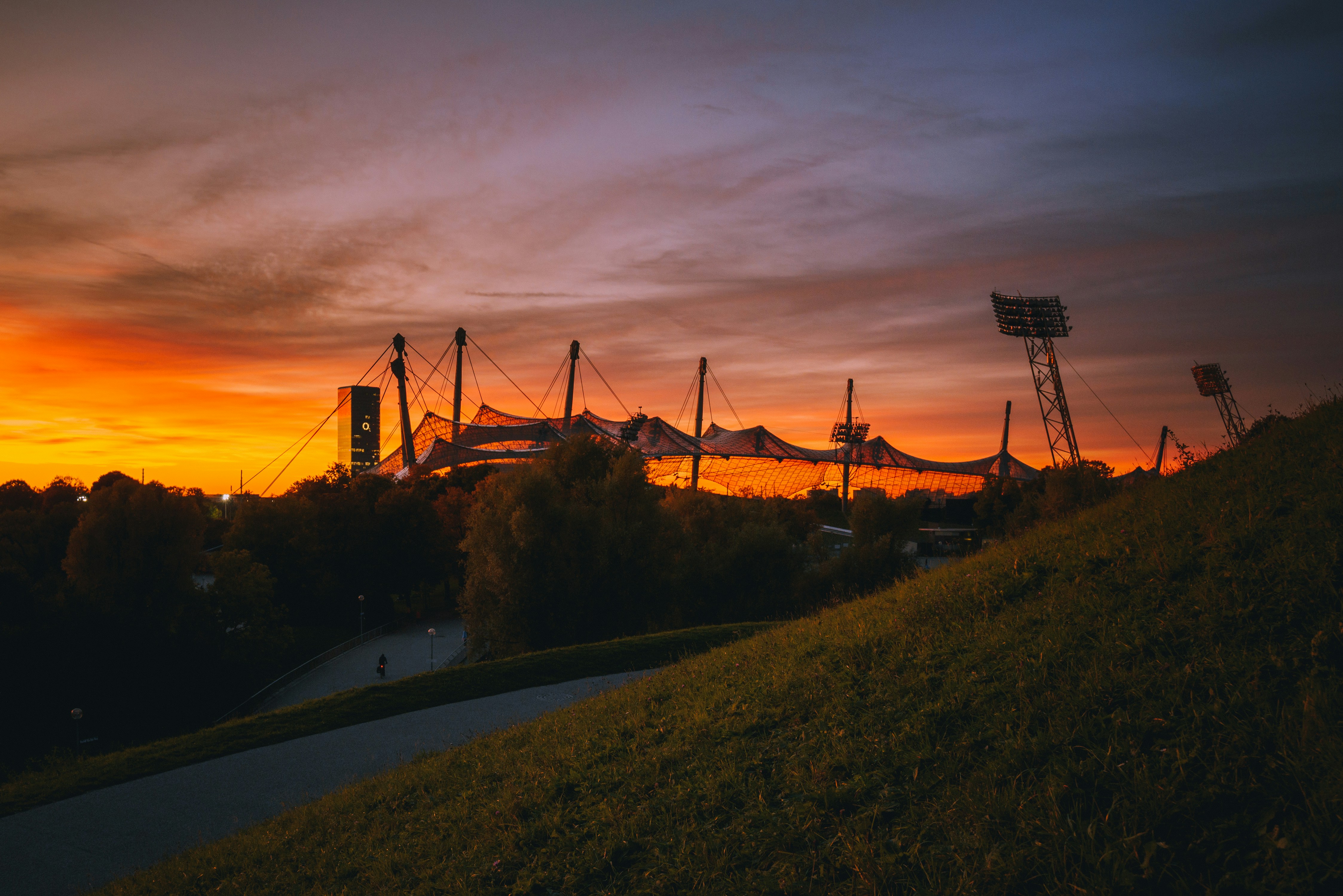 a traffic light in front of a sunset