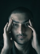 a man with his hands on his face