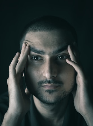 a man with his hands on his face