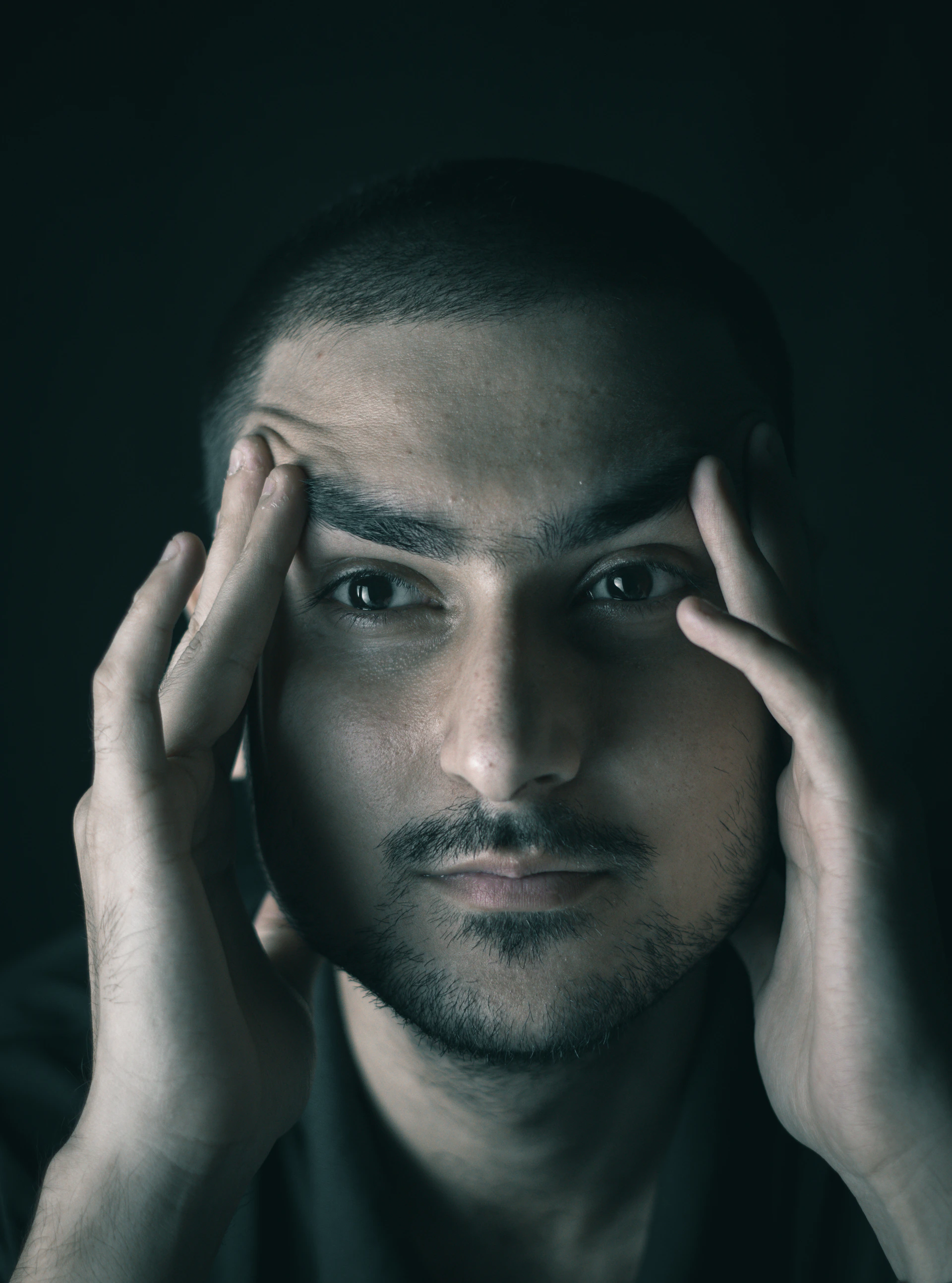 a man with his hands on his face