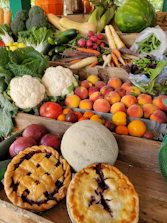 A vibrant display of fresh fruits and vegetables arranged on a rustic wooden table.