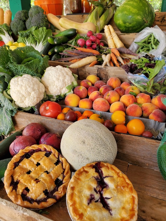 A vibrant display of fresh groceries and bakery items on a wooden table.