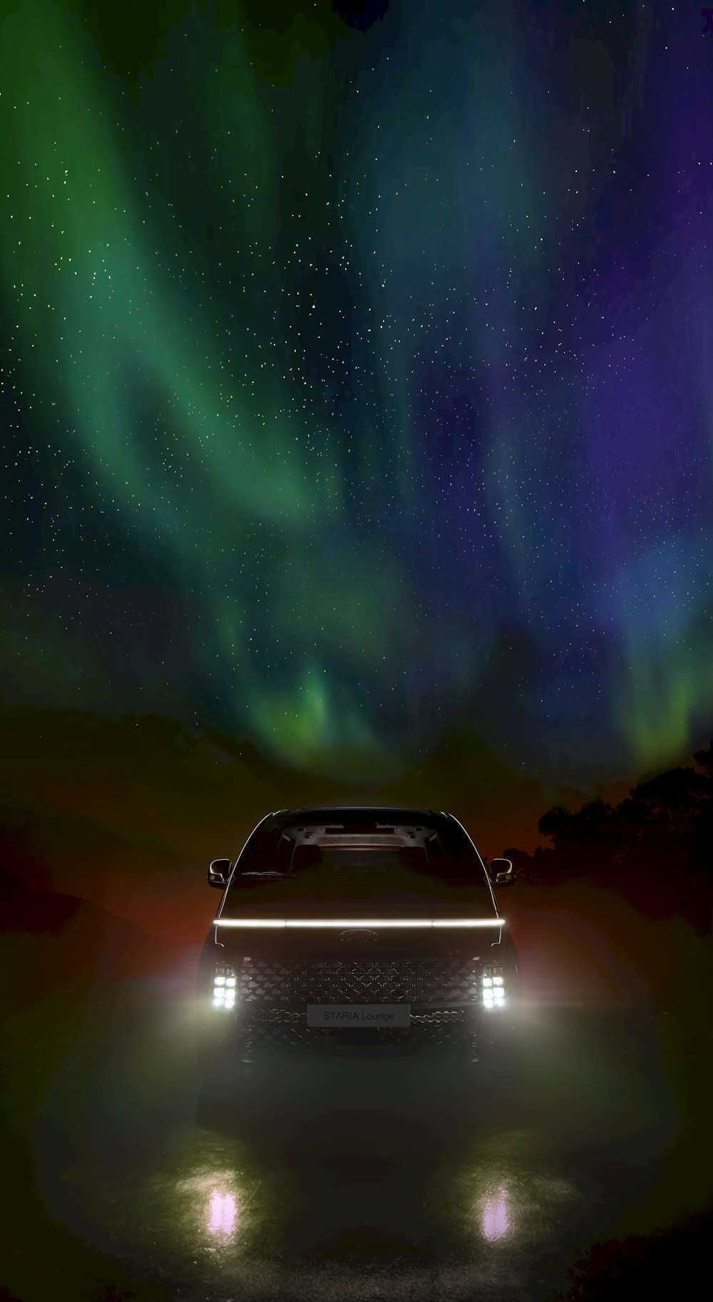 a car in front of a green aurora