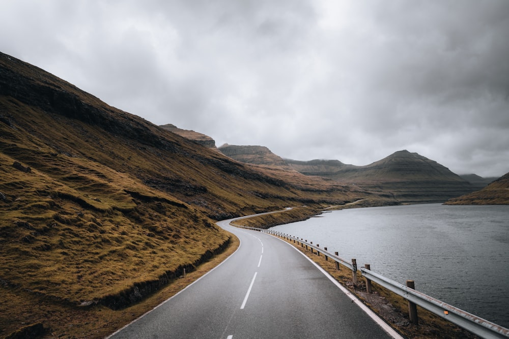 a road next to a body of water