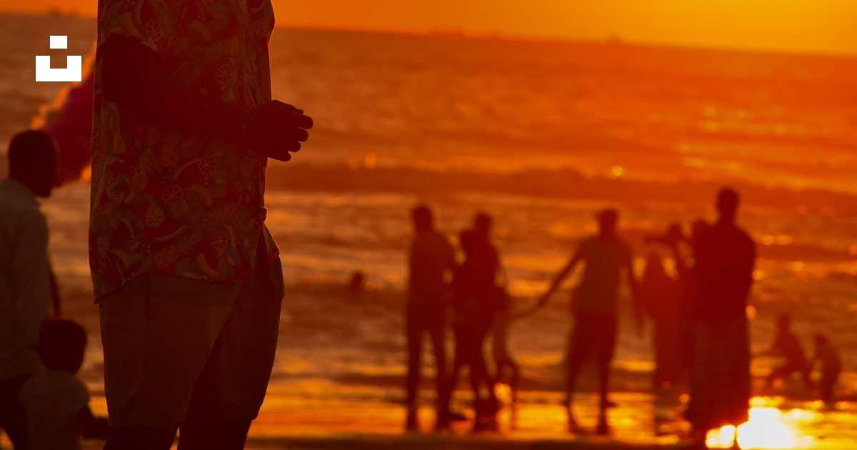 A group of people on a beach photo Free Airbnb sunset beach nc Image