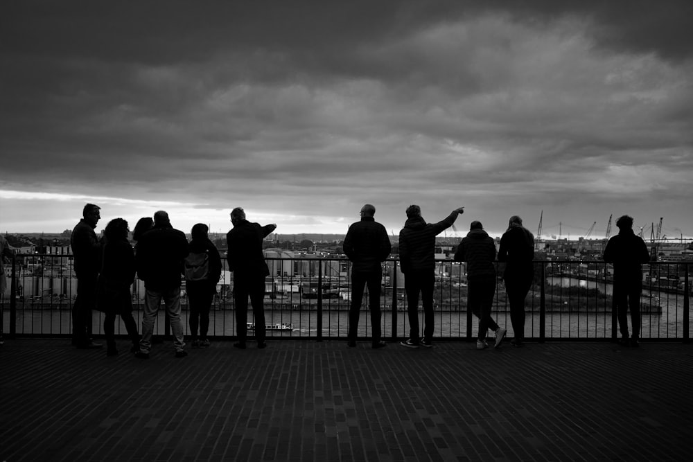 a group of people standing on a pier