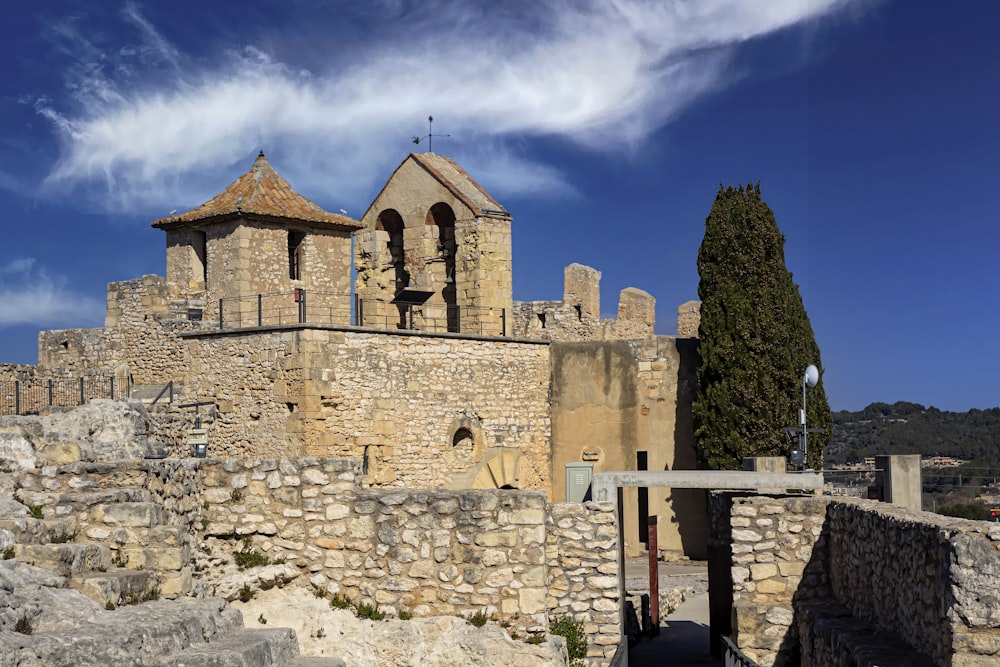 a stone building with a fence