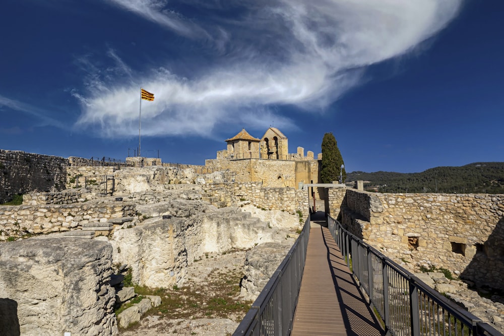 a stone wall with a flag on it and a stone wall with a stone fence and a stone