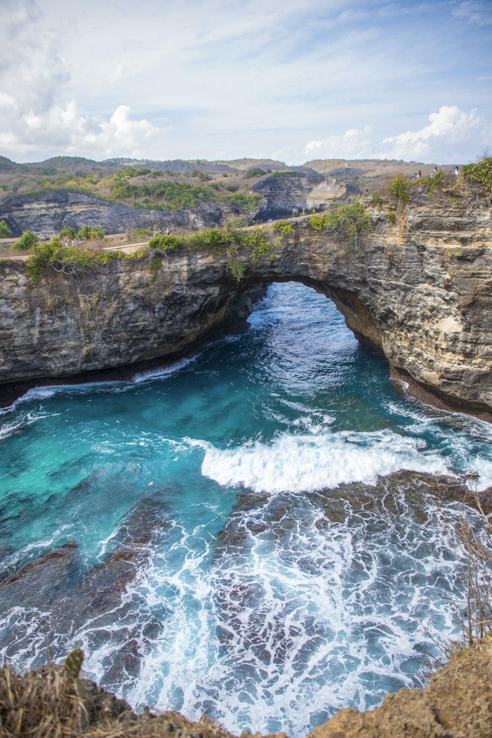 a waterfall with a cliff in the background