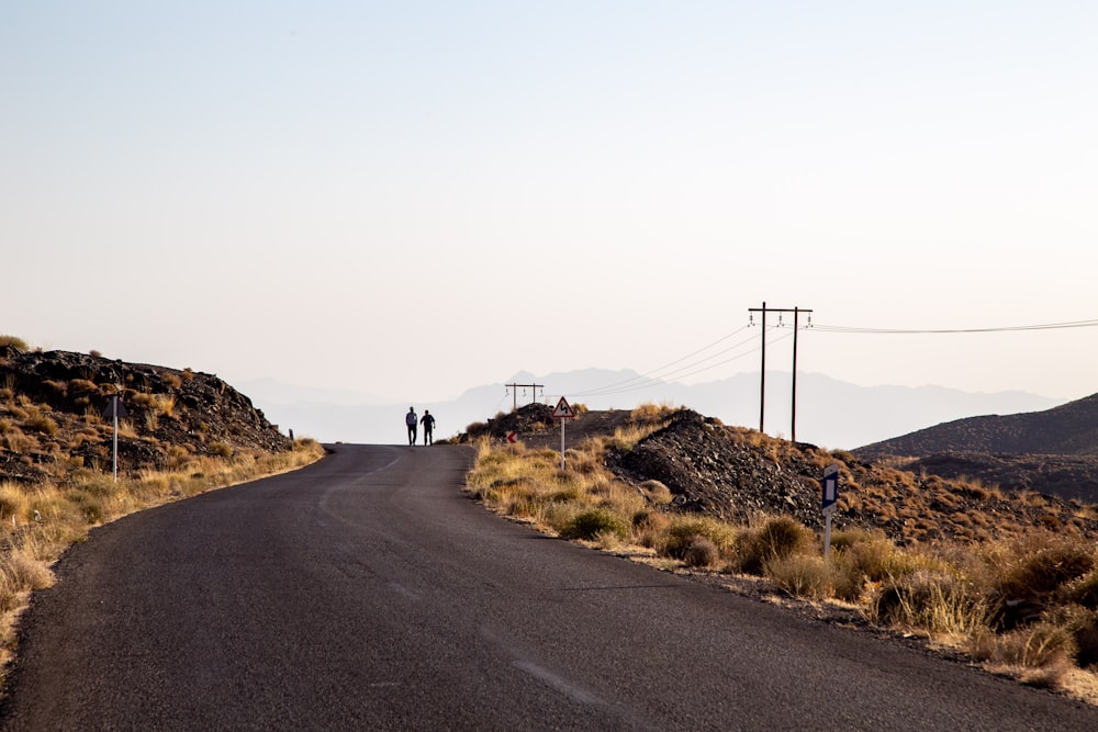 a group of people walking on a road