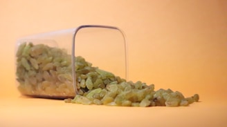 a glass container with green and white food inside