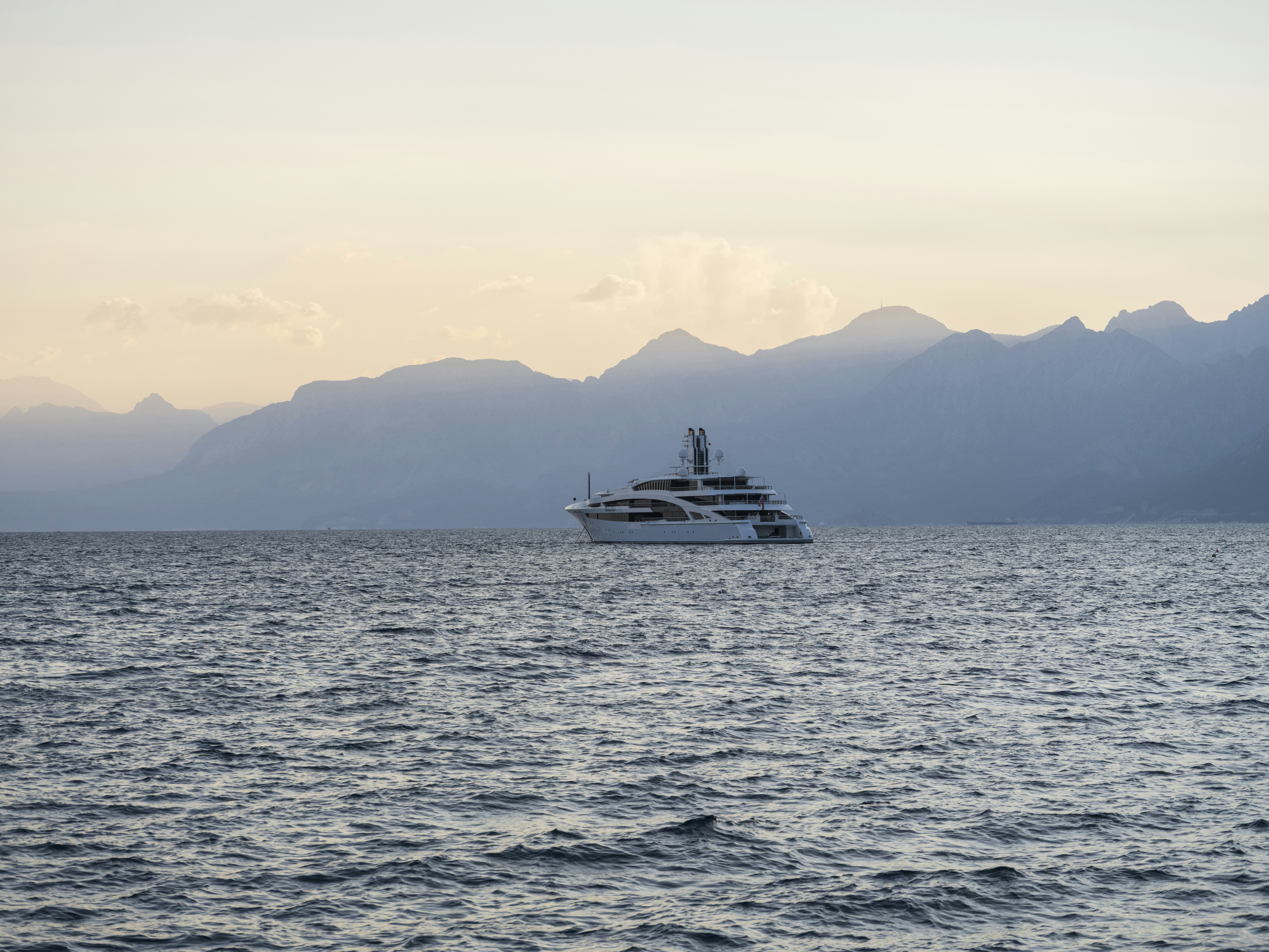 a boat on a body of water with a mountain in the background