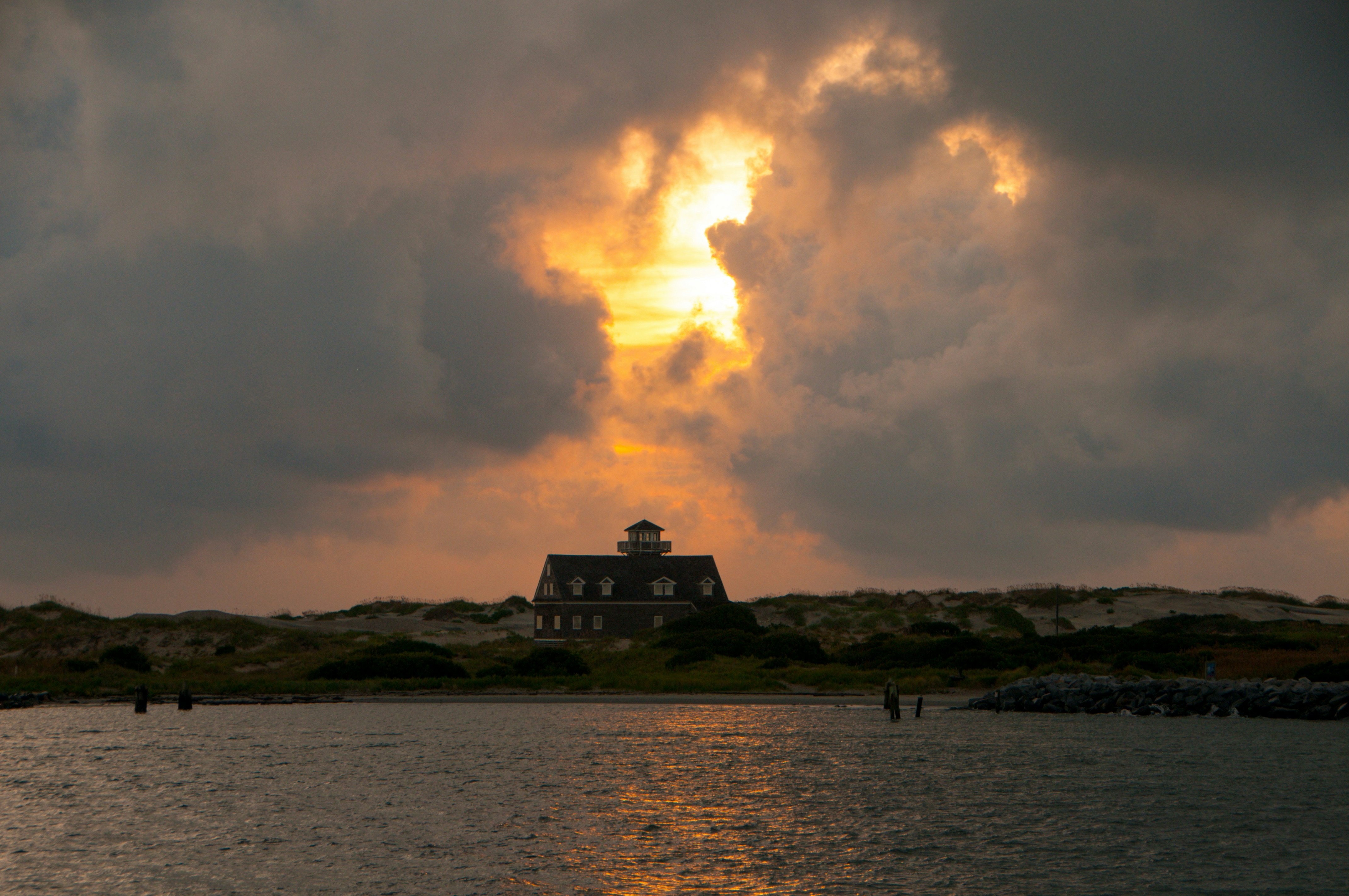 a building on a hill by the water