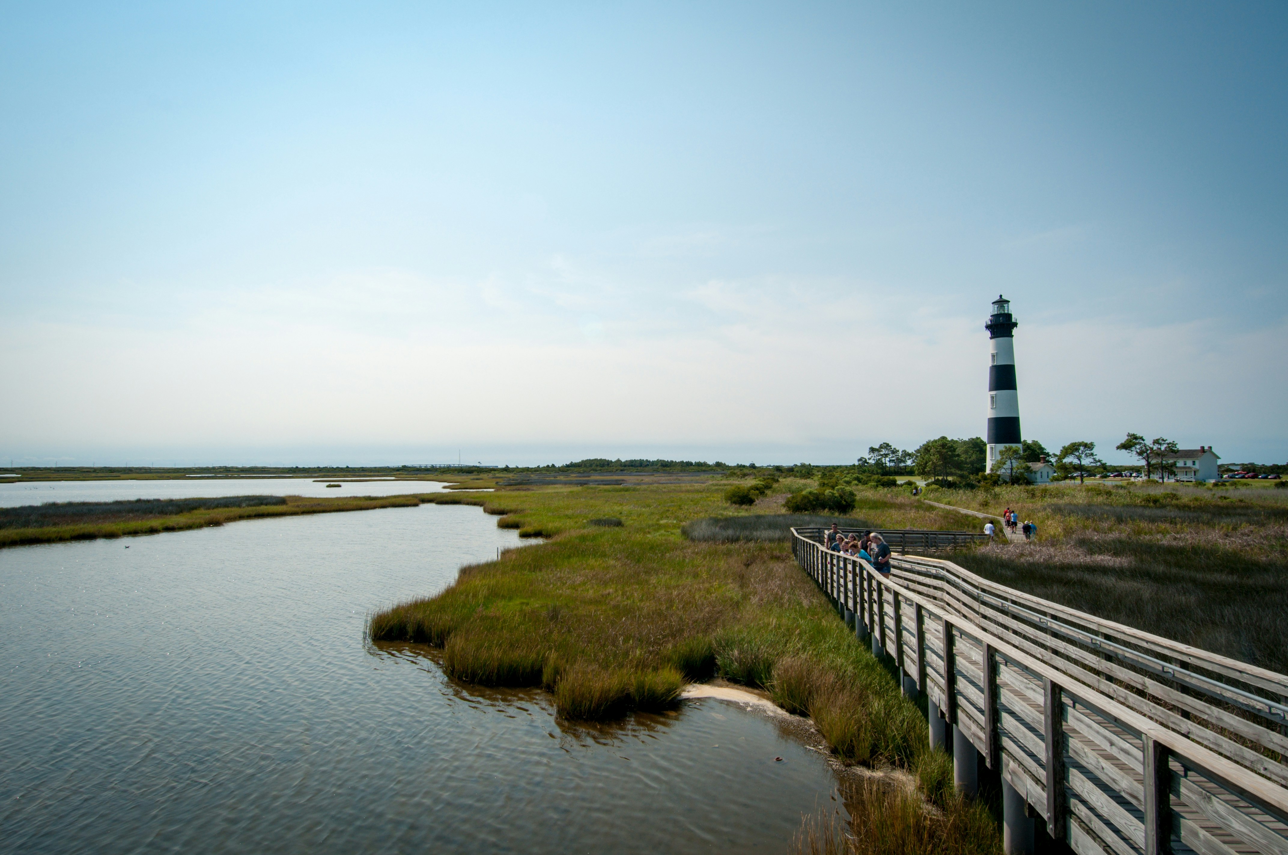 a path with a lighthouse in the distance