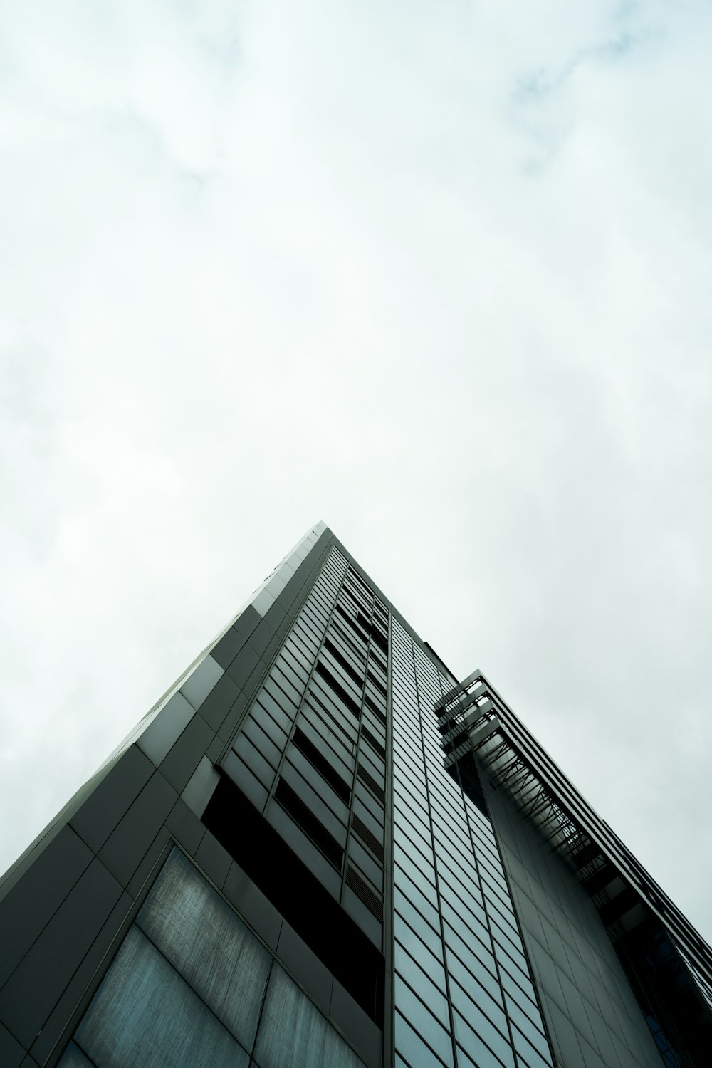 a tall building with a cloudy sky