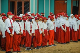 a group of people in red uniforms