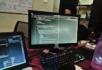A creative workspace with coding on multiple screens.