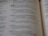 A close-up view of an open book showing text, consisting of paragraphs and numerical headings. The text includes a bolded number 24 and seems to be laid out in a structured format.