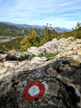 Close-up of a plot boundary marker with scenic hills in the background.