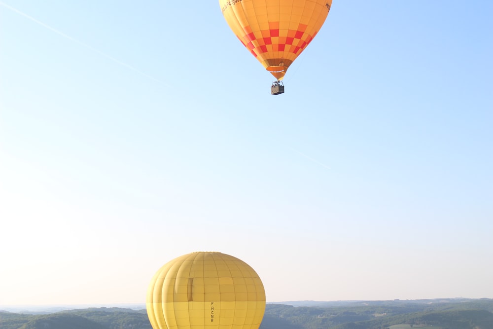 a couple of hot air balloons in the sky