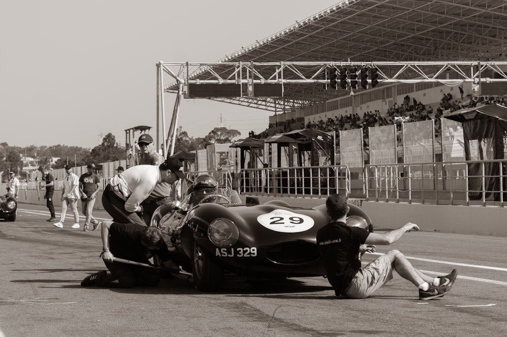 a group of people around a race car